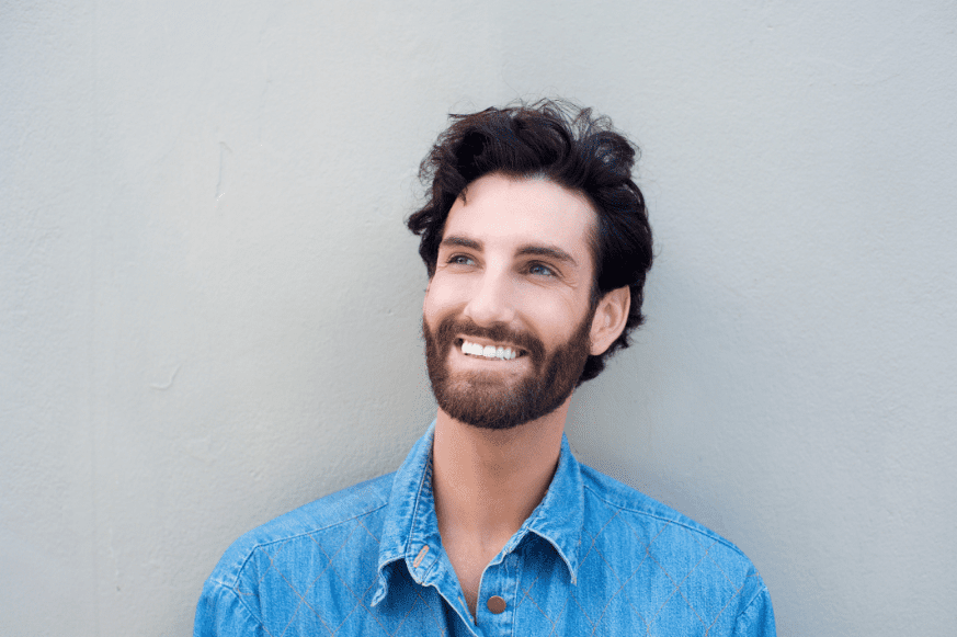 close-up-portrait-smiling-young-man-blue-shirt